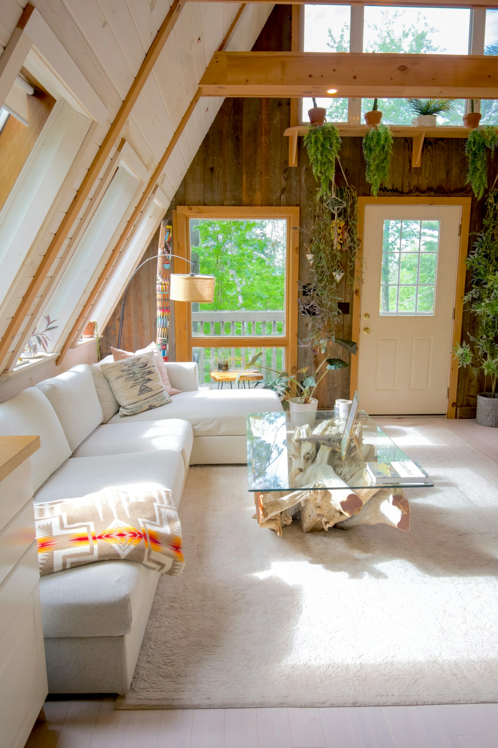 A bright, freshly tidied living room with a comfortable sofa and natural light